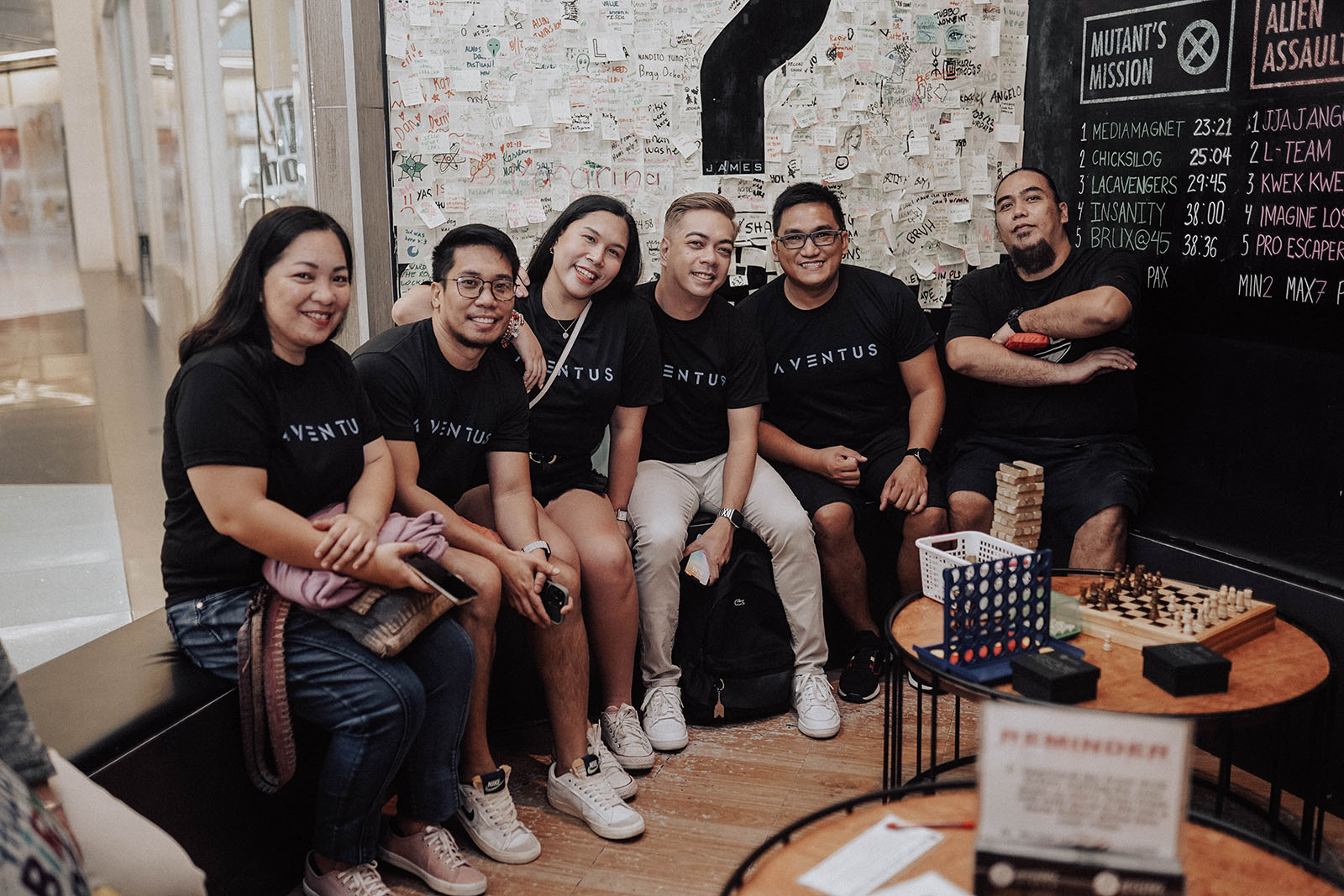 A few members from the Aventus Philippines team sitting at a waiting room before entering a mystery room. Team bonding activity.